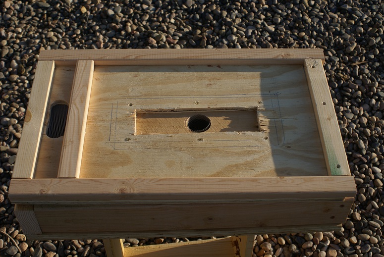 The top of the feeder/bottom of the hive